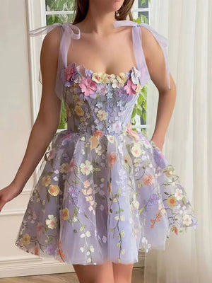 Floral embellished mini dress with tie straps and a sweetheart neckline in lavender tulle.