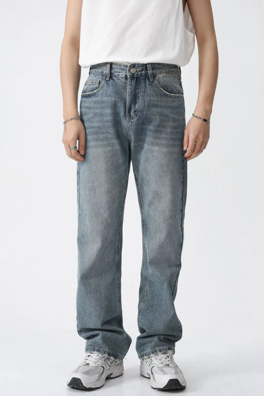 Relaxed wash straight leg denim jeans in medium blue, featuring a classic five-pocket design and a comfortable fit.