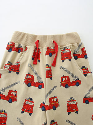 Boys' beige cotton underwear with allover red firetruck print and red drawstring.