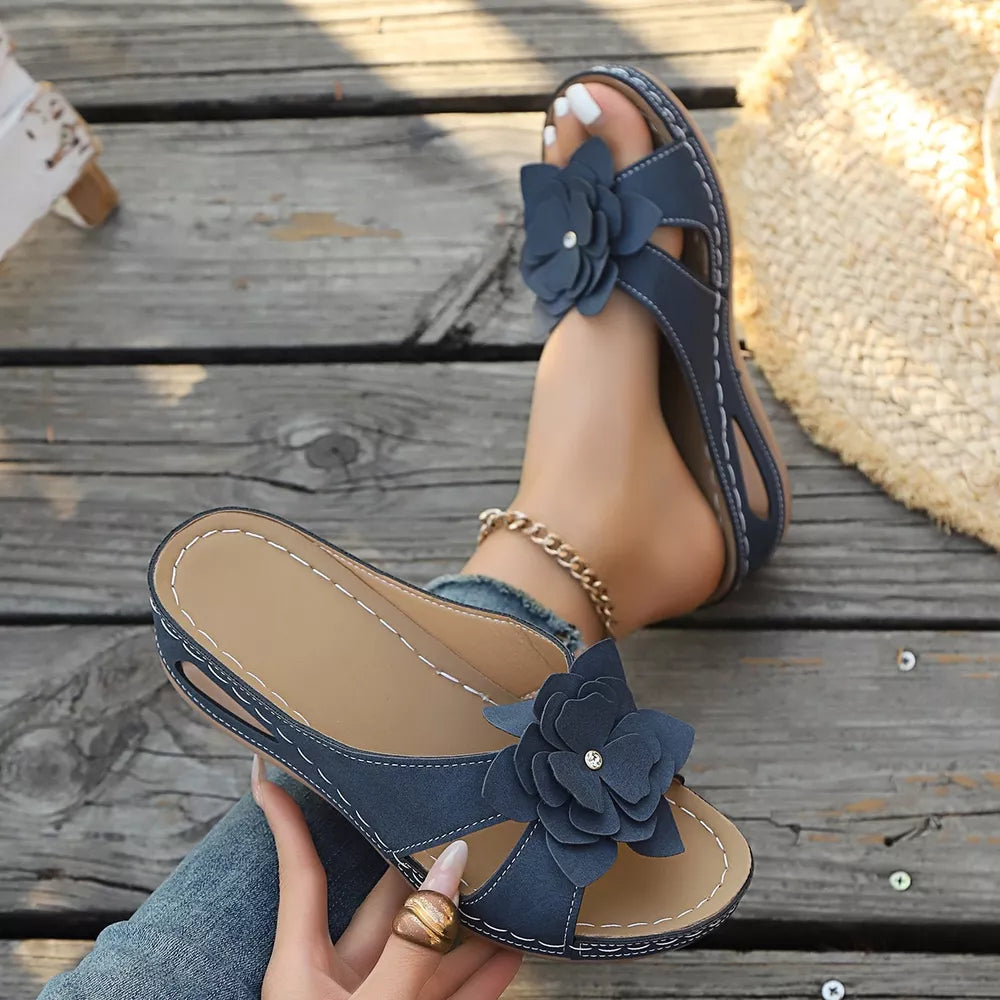 Blue floral embellished mid-wedge sandals with a comfortable cushioned sole.
