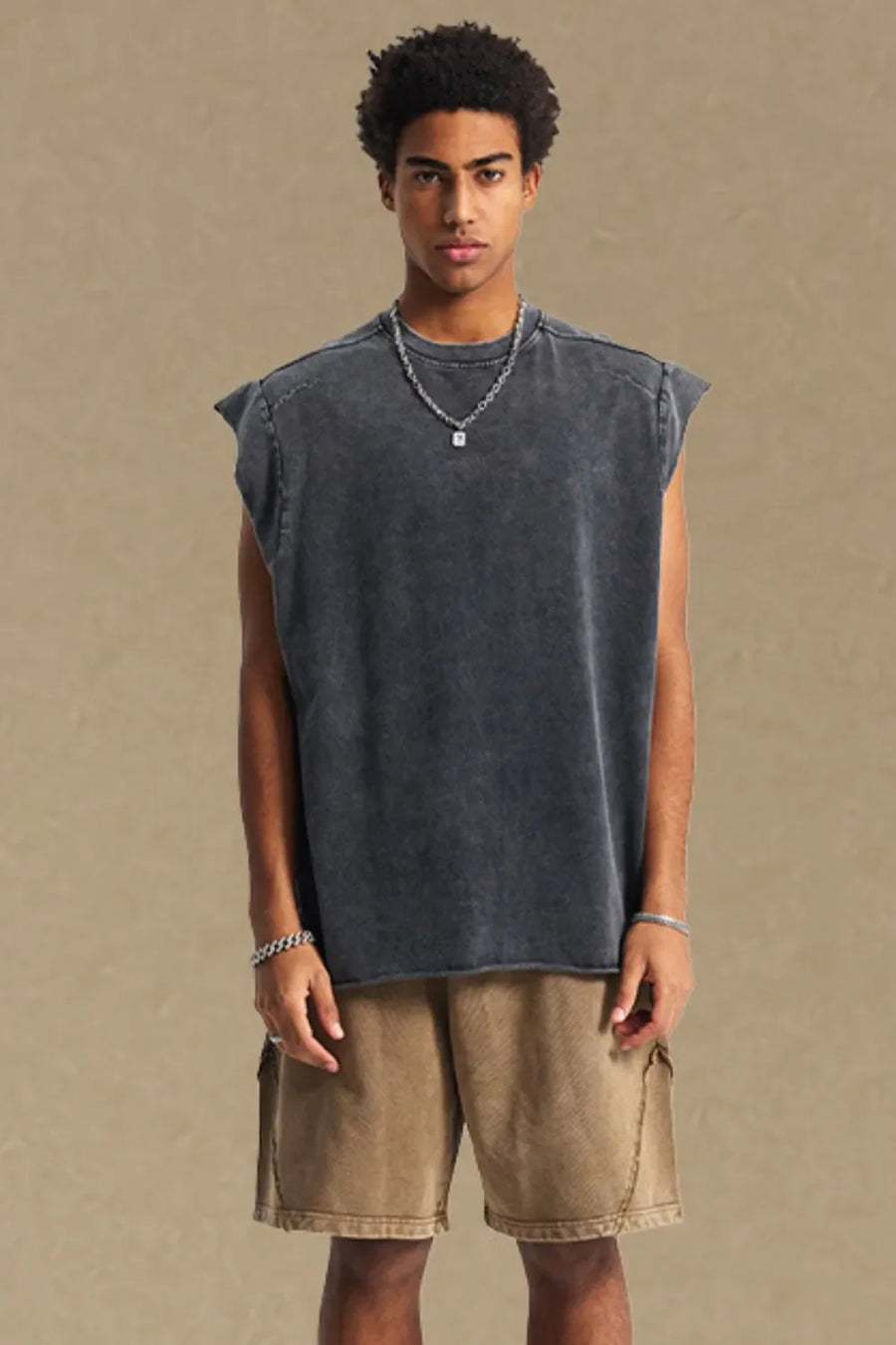 Raw edge muscle tank top in dark gray with a washed effect and raw hem.
