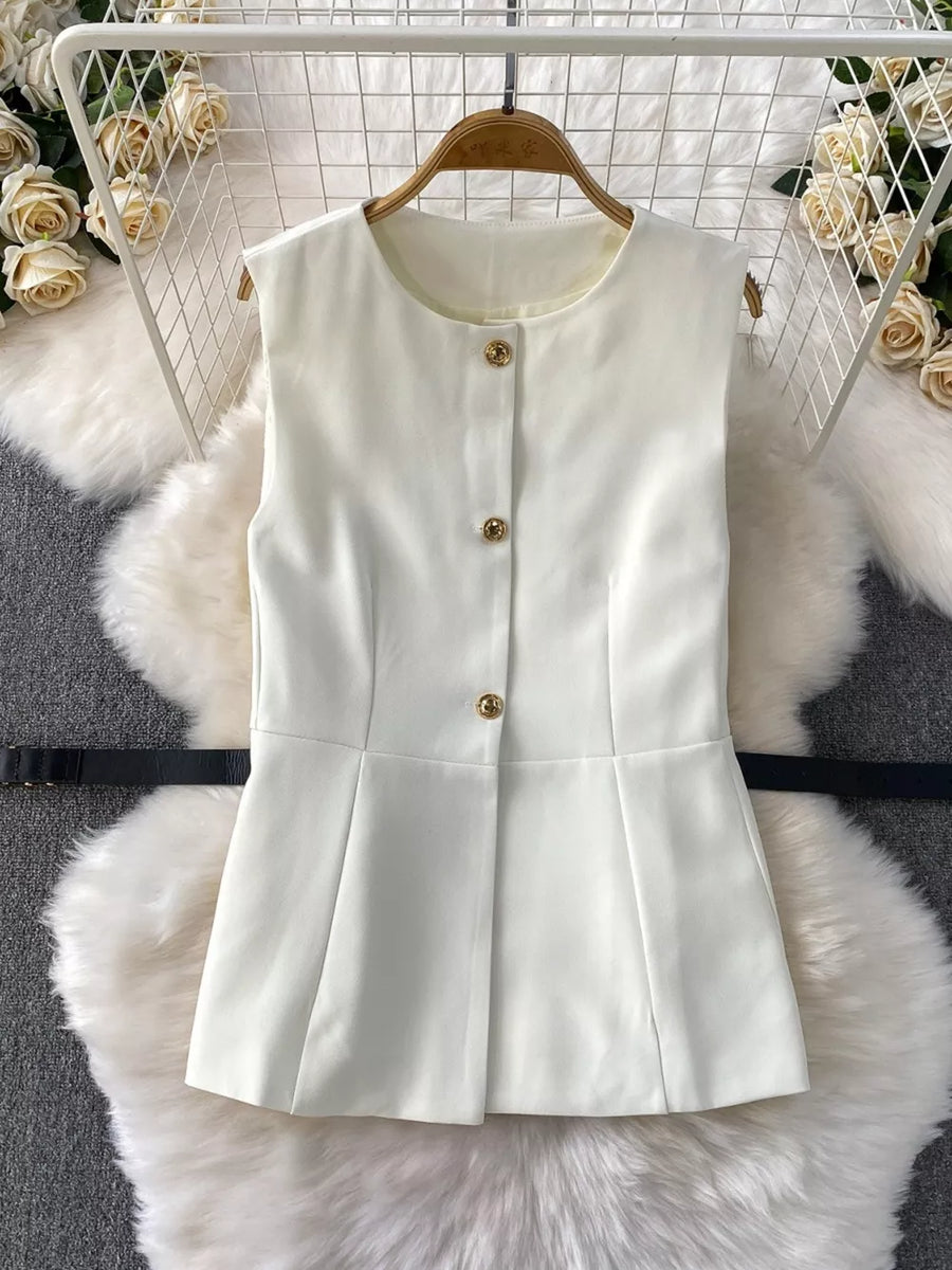 White belted sleeveless outfit set with gold buttons and pleated hem.