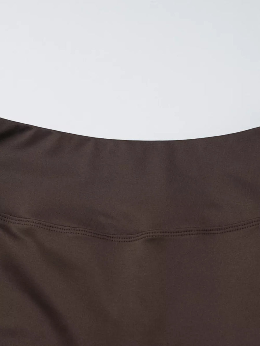 Brown halter crop top and wide-leg pants set detail showing stitching.