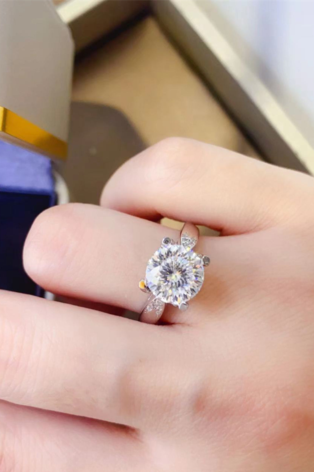 Sterling silver solitaire ring with a brilliant halo and accent stones.