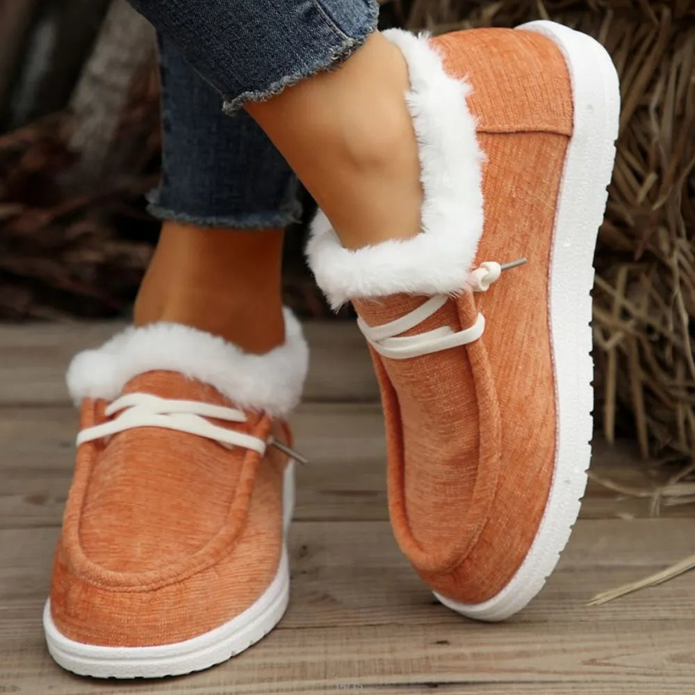 Tangerine sherpa-trimmed slip-on sneaker booties with white laces and soles.