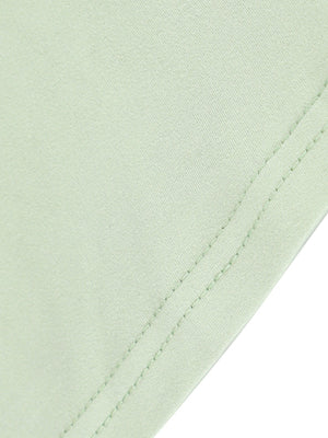 Light green ruffled mermaid maxi dress detail showing fabric texture and double stitching.