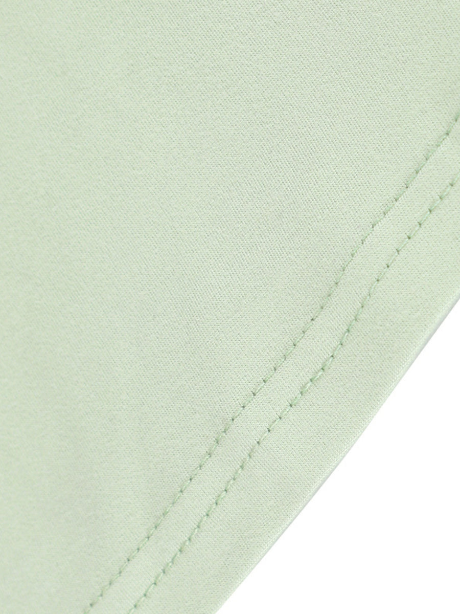 Light green ruffled mermaid maxi dress detail showing fabric texture and double stitching.