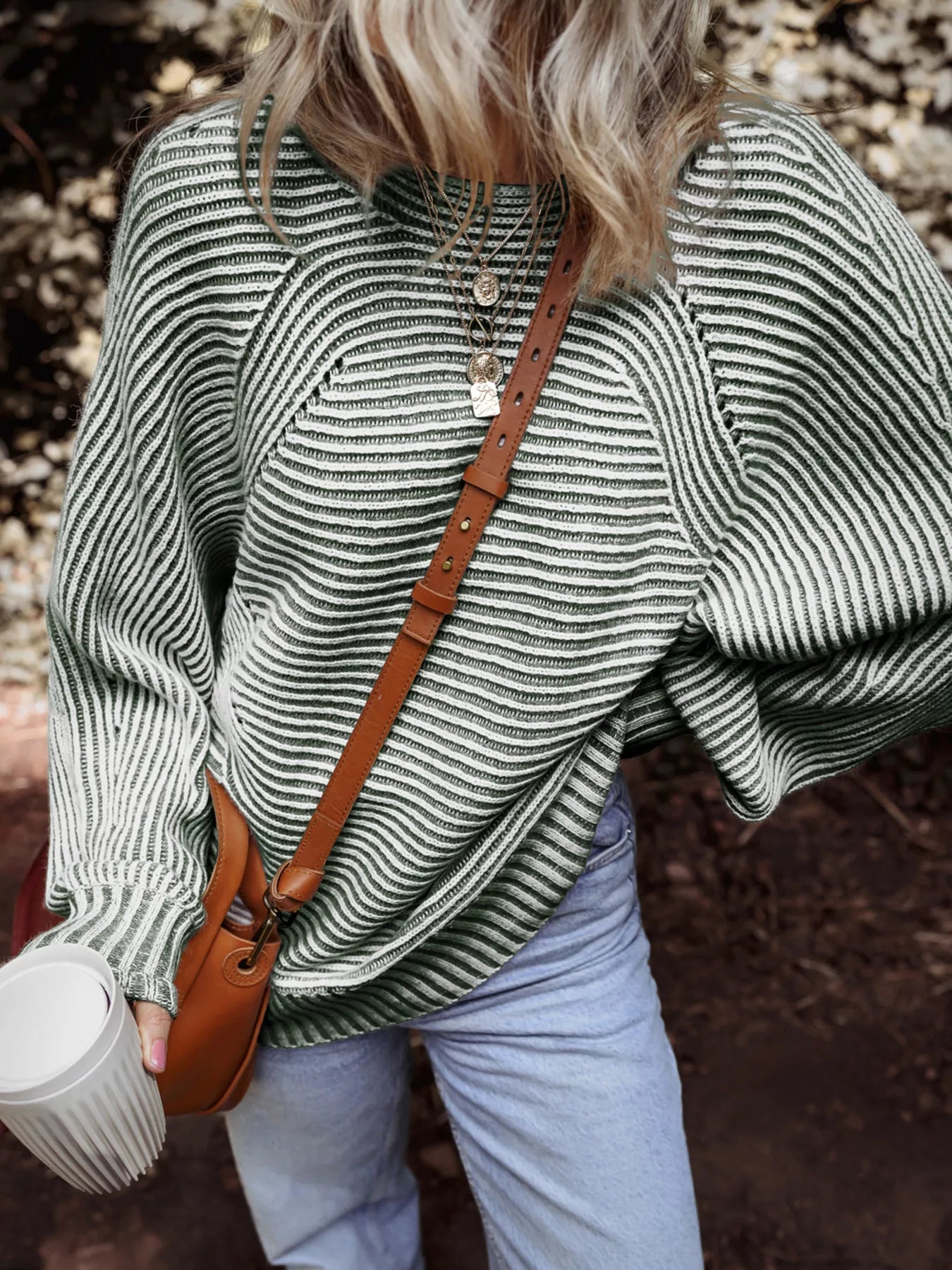 Relaxed ribbed knit sweater with boat neck and stripe pattern in green and white.