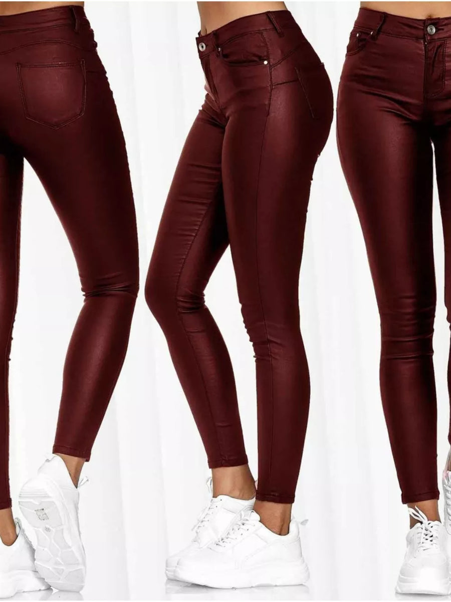 High-waisted red faux-leather skinny pants with a shiny finish.