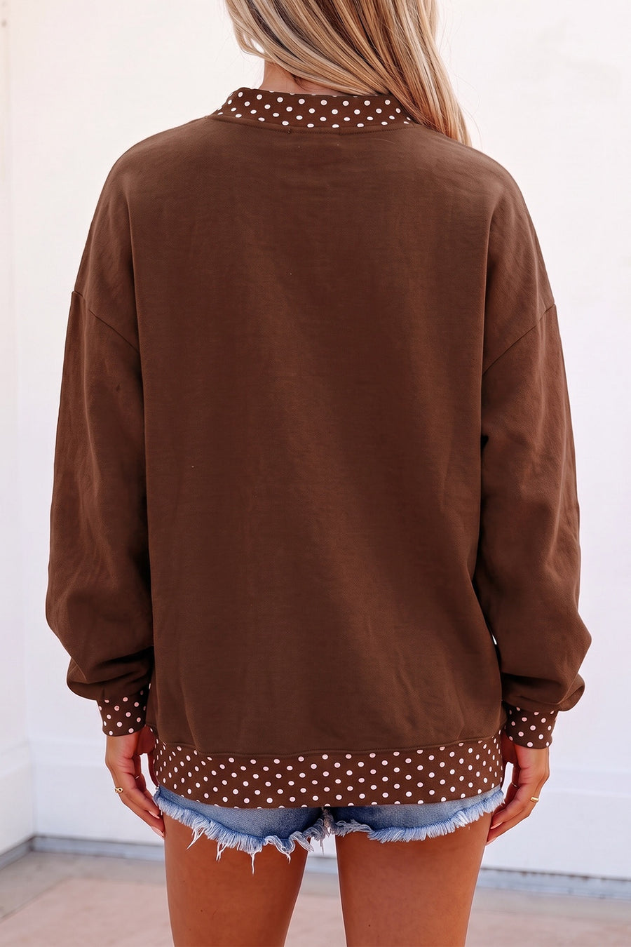 white sweatshirt featuring oversized and polka dot