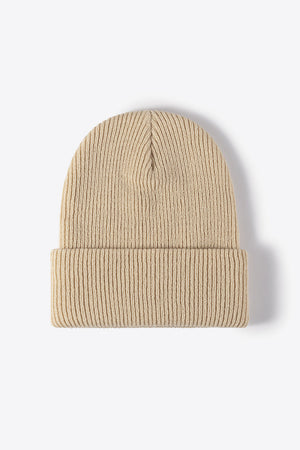 Beige ribbed knit beanie with a cuffed brim.