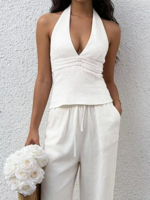 White halter neck tank top with decorative buckles and V-neckline