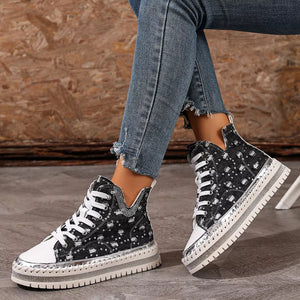 Black canvas high-top platform sneakers with white laces and rhinestone trim.
