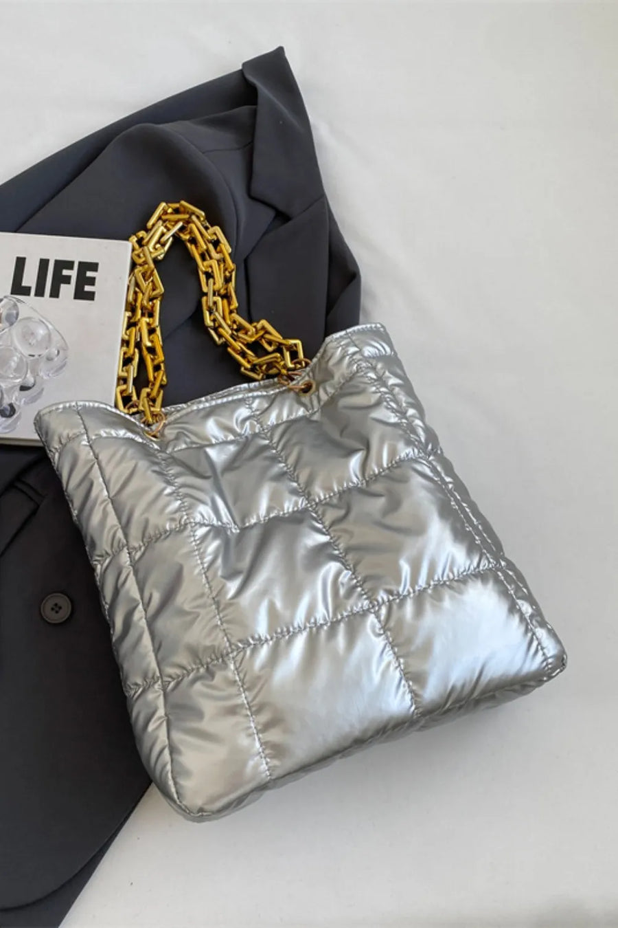Silver quilted nylon tote bag with gold chain handle