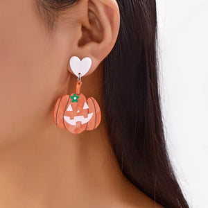 white earrings featuring drop design and graphic print