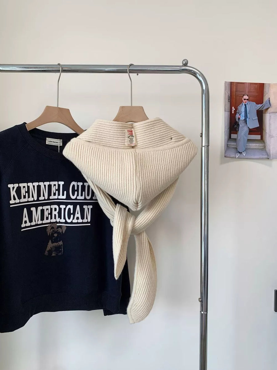 Cream ribbed knit neck warmer with tie detail, a cozy winter accessory.