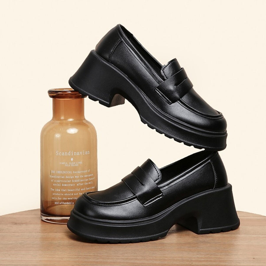 Black round toe block heel loafers with a chunky sole and classic strap detail.
