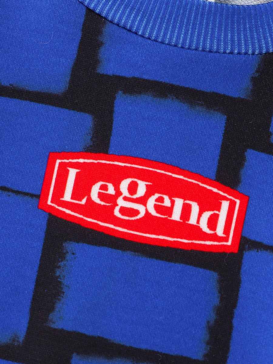 Children's blue graphic tee with abstract block pattern and red "Legend" patch.