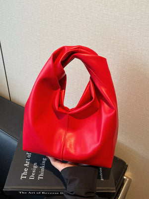 Deep Red leather shoulder bag with a unique knot handle and slouchy design