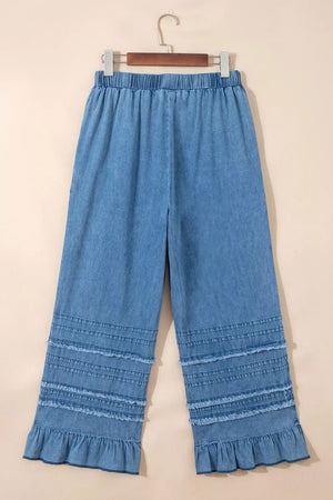 Maternity wide-leg chambray jeans in light blue denim with ruffled hem and drawstring waist.