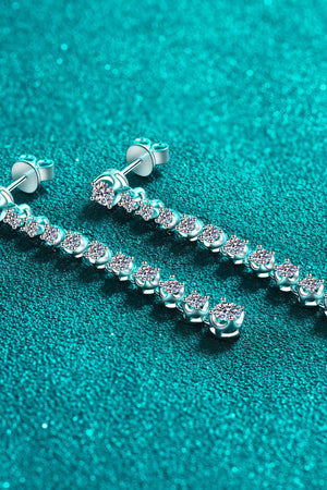 Silver moissanite linear drop earrings with multiple sparkling stones.