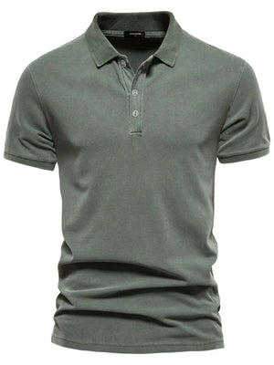 Sage green textured polo shirt with short sleeves and buttoned placket.
