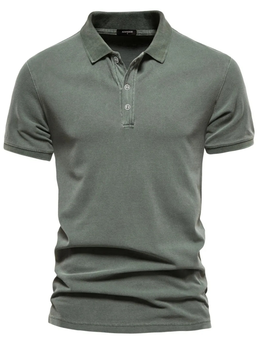 Sage green textured polo shirt with short sleeves and buttoned placket.
