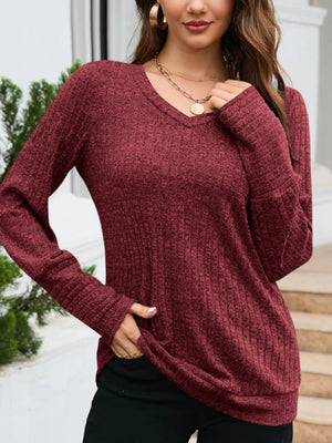 Textured red V-neck knit long-sleeve top with ribbed cuffs and hem