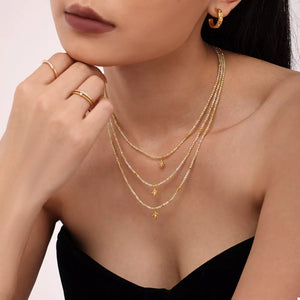 gold necklace with star and round neck