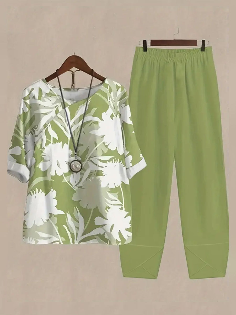 Floral print half sleeve top and lime green pants set with round neckline and cuffed sleeves.