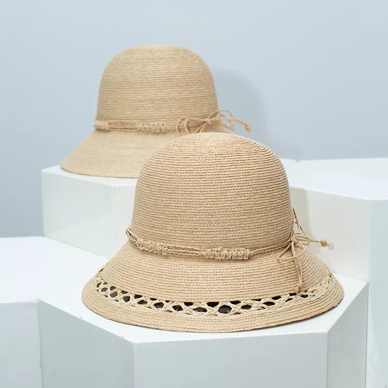 Woven straw bucket hat in Style B with twisted band and openwork brim detail.