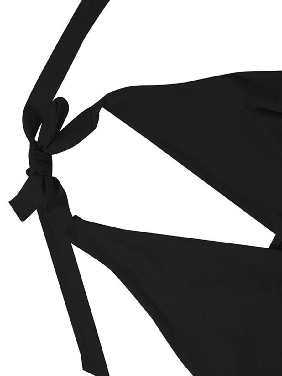 Black backless mini dress with ruffled details and tie straps.