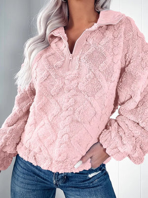 Pink textured fleece quarter zip sweatshirt with diamond pattern and ribbed collar.