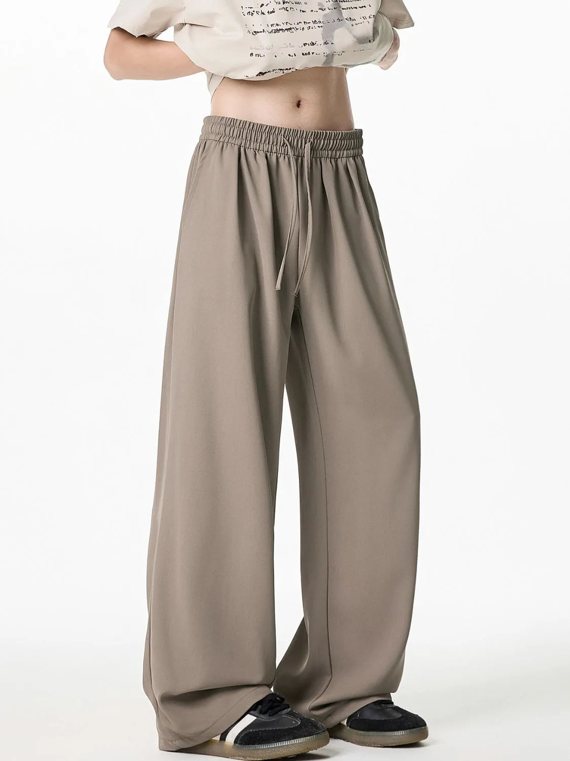 Relaxed taupe palazzo trousers with drawstring waist and wide leg.