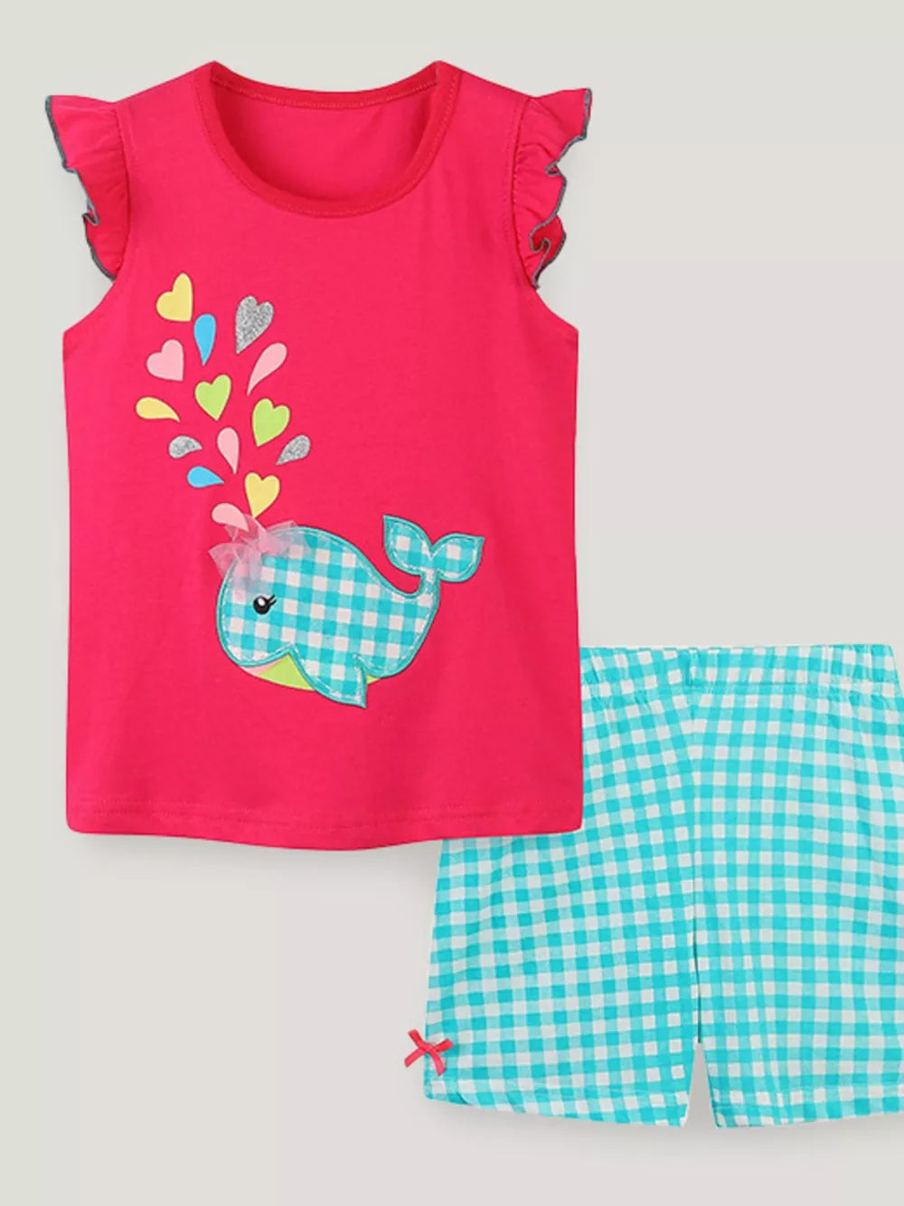 Toddler girls' pink whale print pajama set with ruffled cap sleeves and blue gingham shorts.
