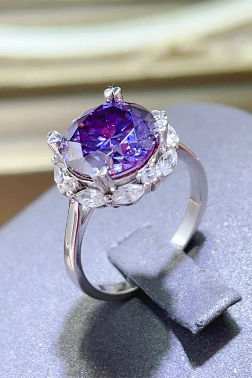 Amethyst halo cocktail ring in silver with clear accent stones.