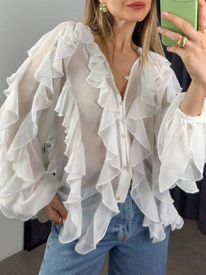 White sheer long-sleeve blouse with dramatic ruffles and button front.