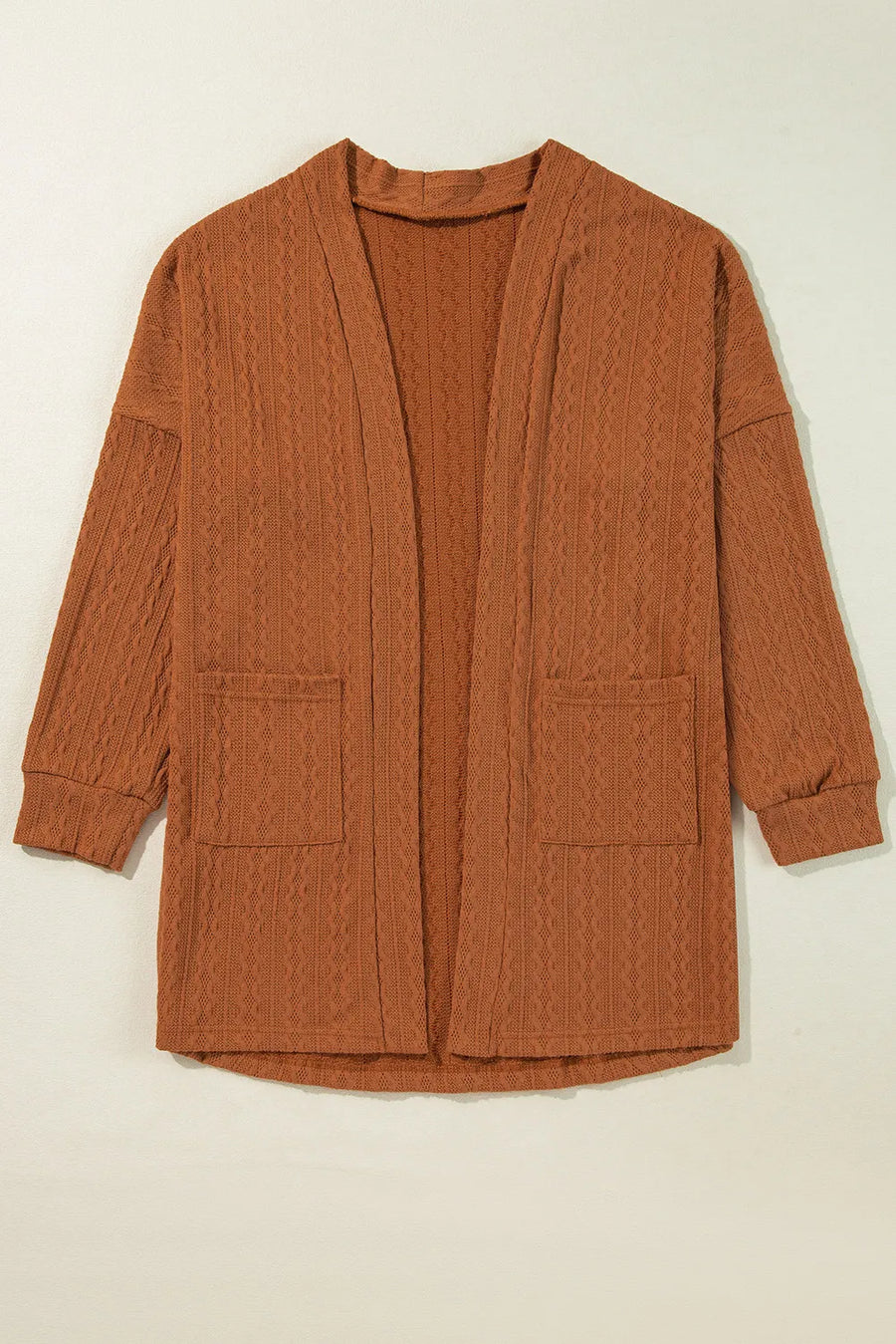Terracotta open front cardigan with cable knit texture and two front pockets.