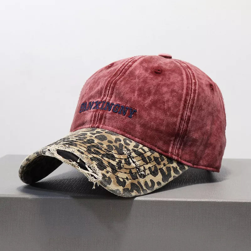 Wine red distressed baseball hat with leopard print brim and embroidered text
