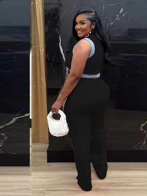 Black zip-front crop top and wide-leg pants set with denim trim.