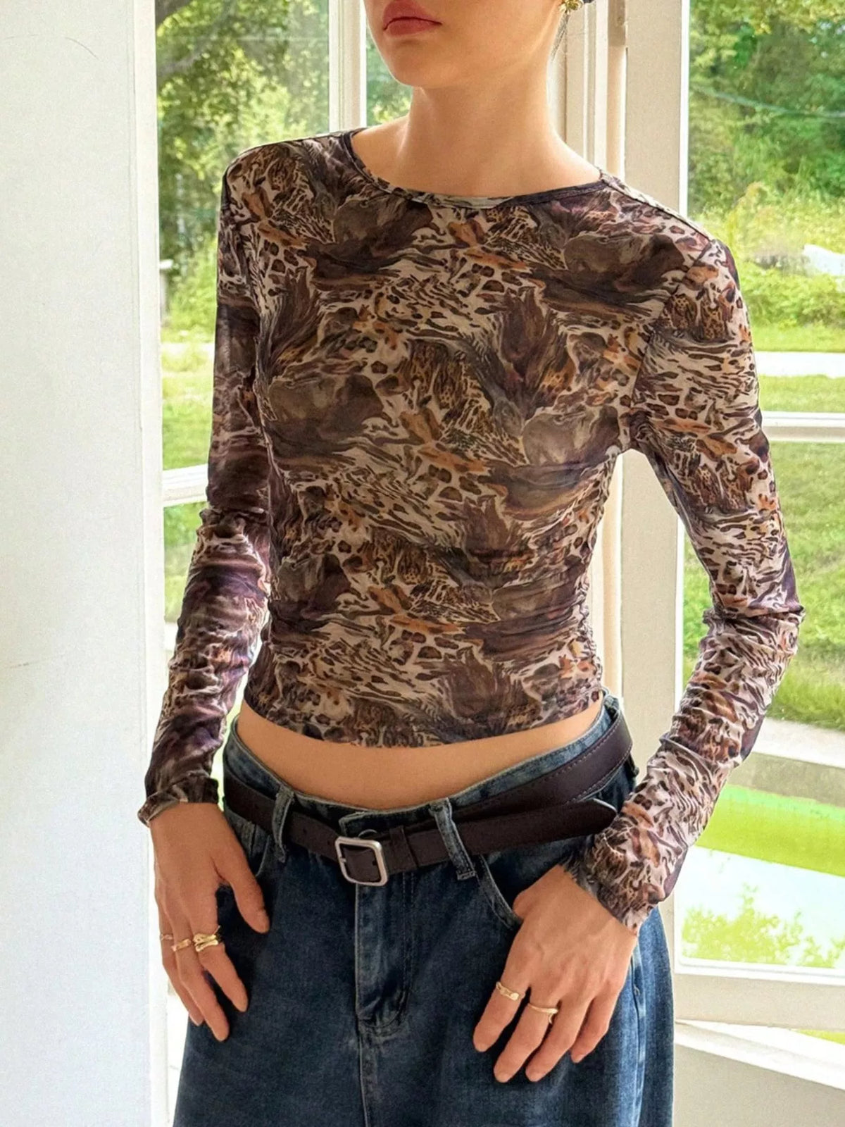 Sheer leopard print long-sleeve top in brown with a crew neck.