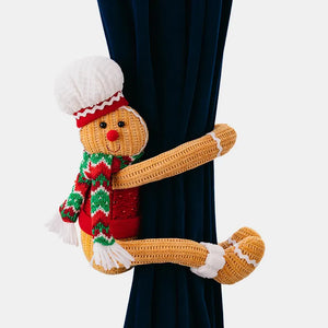 Gingerbread man curtain tieback with red vest, green and red scarf, and white chef hat.