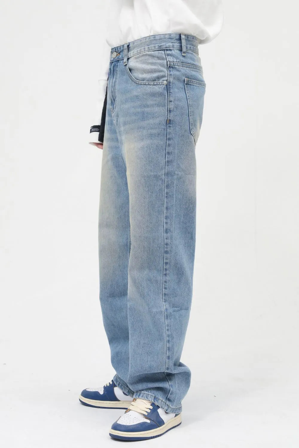 Faded wash relaxed fit jeans in medium blue denim with a casual, breathable style.