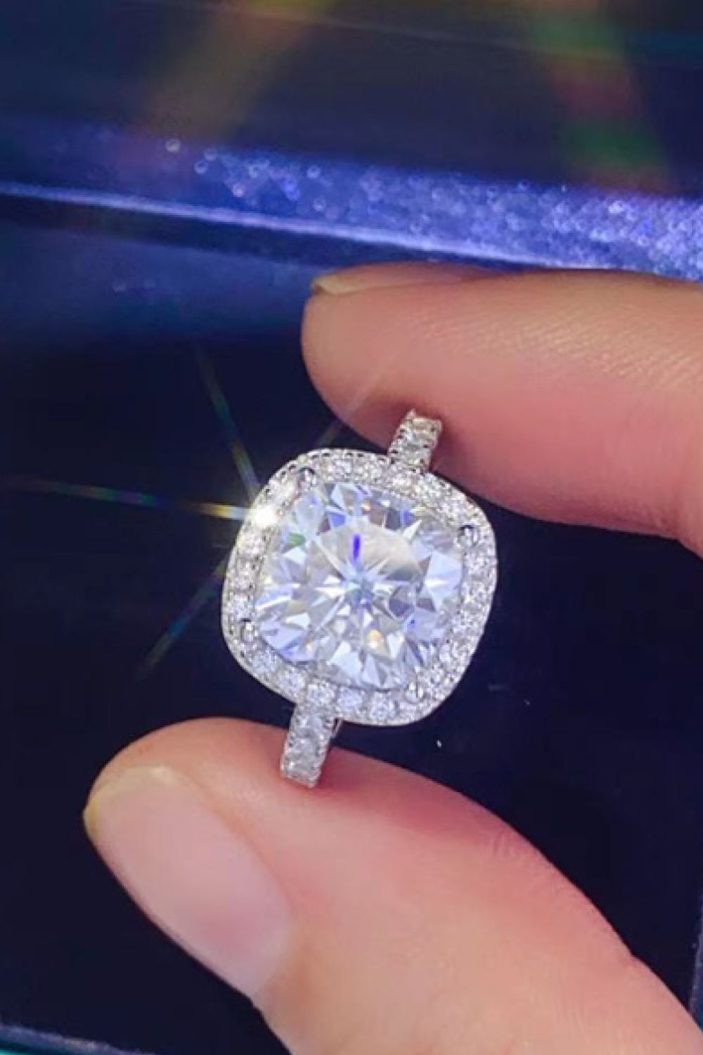 White cushion cut halo engagement ring with sparkling diamonds