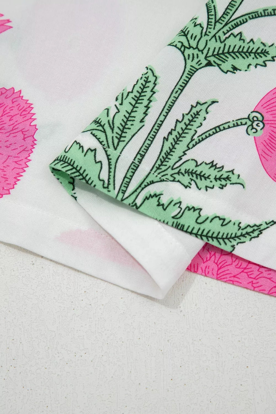 White cotton blouse with vibrant pink floral and green leaf print
