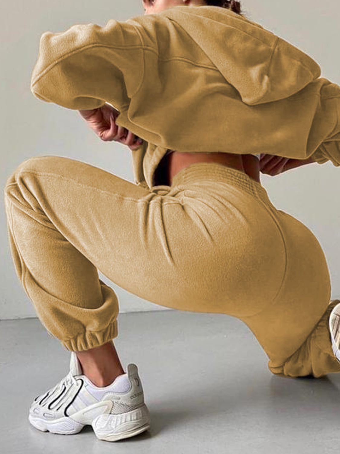 Tan fleece hoodie and jogger set with cinched waist and cuffs.