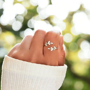 Silver ring with delicate zirconia leaf branches wrapping around finger