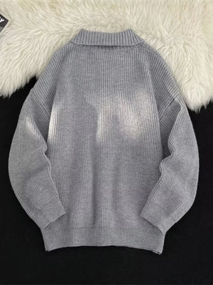 Light gray ribbed zip-up knit cardigan with a mock neck and cuffed sleeves.