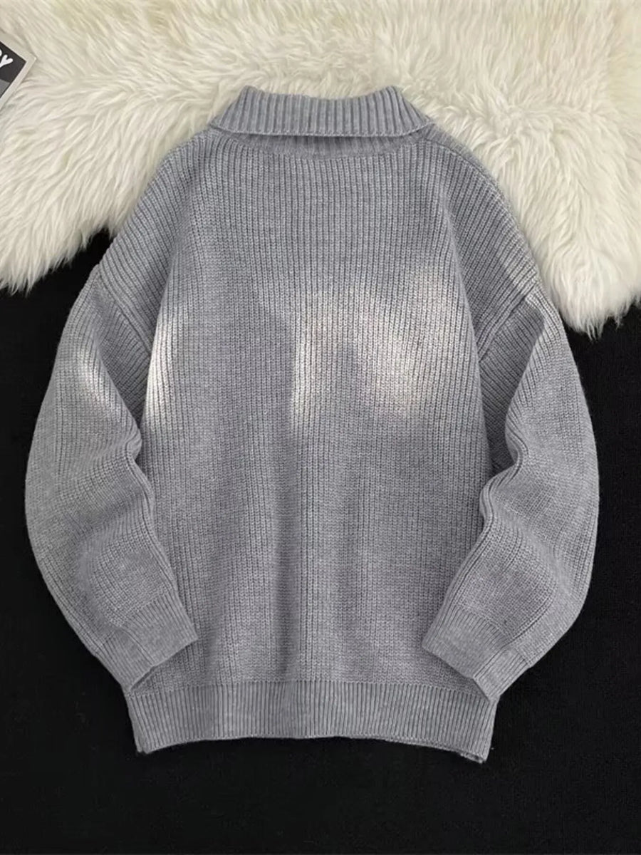 Light gray ribbed zip-up knit cardigan with a mock neck and cuffed sleeves.