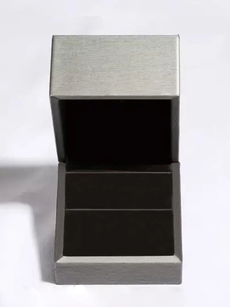 Silver ring box with open lid and black interior.